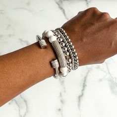 Add extra dazzle to your outfit with this gorgeous stack of bracelets. With a mix of delicate and bold pieces, sparkly rhinestones and glimmering metallics, the Annabella bracelet stack has everything you need to dress up any look. This bracelet stack includes: - Terri stainless steel and rhinestone cuff bangle - Tanisha howlite beaded bracelet with rhinestone bar - 2 Nakia stainless steel beaded bracelets (6mm and 8mm) - Nyoki stainless steel bracelet This bracelet stack will fit wrists up to 7 Glamorous Adjustable Bracelet With Bling, Adjustable Glamorous Bling Bracelets, Glamorous Adjustable Bling Bracelets, Glamorous Adjustable Bling Bracelet, Silver Beaded Bling Bangle Bracelets, Silver Sparkly Beaded Bangle Bracelet, Silver Bling Beaded Bangle Bracelet, Trendy Stackable Metal Beaded Bracelets, Adjustable Silver Tennis Bracelet