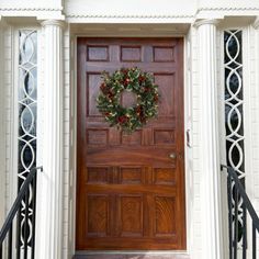 a wooden door with a wreath on it