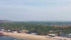 an aerial view of a beach with houses and palm trees