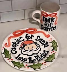 a white plate with a santa clause on it next to a coffee mug