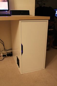 a computer monitor sitting on top of a wooden desk