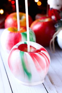 two candy apples sitting on top of a white table