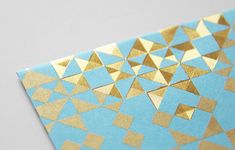 a piece of paper with gold triangles on it