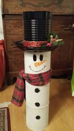 a snowman made out of paper plates sitting on top of a wooden table