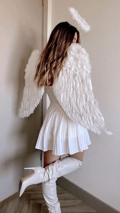 a woman in white boots and angel wings