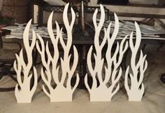 three white paper cutout trees sitting on top of a table