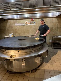 a man standing in front of a large grill