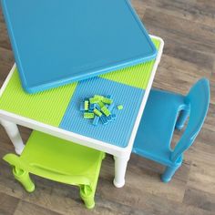 a child's table and chair set with blue top, green bottom and yellow legs