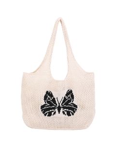 a white handbag with black and white butterflies on the front, sitting against a white background