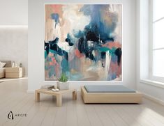 an abstract painting hangs on the wall above a bed in a room with white walls