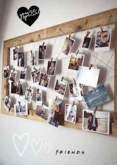 a wooden frame with pictures hanging on it and the word friends written in black ink