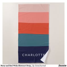 a beach towel with the name charlotte printed on it in blue, pink, and orange