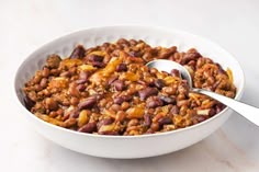 a white bowl filled with beans and other food