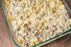 a casserole dish with meat and cheese in it sitting on a table top