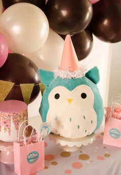 an owl themed birthday party with balloons and cake