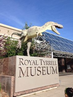 there is a statue of a dinosaur in front of the royal tyrell museum