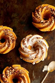 cinnamon rolls with icing and nuts on top