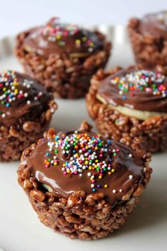 chocolate desserts with sprinkles and frosting on a white plate