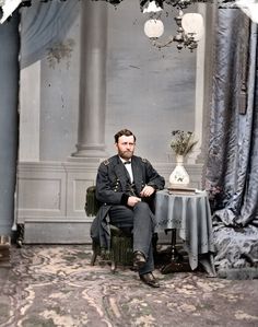 an old photo of a man in uniform sitting at a table with a vase on it