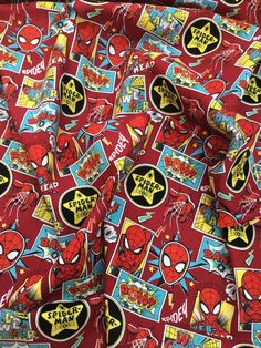 the red spiderman fabric has many different stickers on it and is very colorful