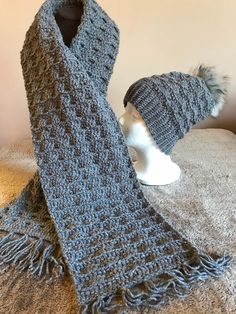 a knitted scarf and hat sitting on top of a table