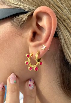 Add a pop of color to your style with these stunning earrings! Each pair features a unique design that will make a statement. The first pair features a large hoop earring with shiny fuchsia enamels that are sure to catch the eye. The middle pair features a tiny gold hoop, adding a touch of sophistication to the mix. And the last pair features a tiny stud earring with a star design and fuchsia enamel that is perfect for everyday wear. These earrings are comfortable to wear and easy to style, maki Vibrant Pink Jewelry For Gift, Vibrant Pink Jewelry Gift, Vibrant Pink Jewelry For Party, Handmade Vibrant Pink Earrings, Vibrant Pink Handmade Earrings, Vibrant Handmade Pink Earrings, Earring Gold, Tiny Studs, Statement Earring