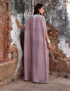 The ensemble includes an embellished choli paired with an equally embellished cape and a draped skirt. This combination exudes sophistication and glamour, making it perfect for special occasions or festive events. Cape Set, Draped Skirt, Cape, Lilac, Special Occasion, Festival, Skirt