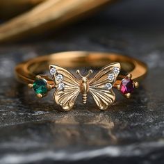 Detail: 14k Gold Plated Diamond Butterfly Ring, Emerald & Ruby Butterfly Ring, unique butterfly Ring, Multi gem butterfly Ring, Cz Butterfly Ring 💜Item Name: diamond butterfly ring  💜Metal : 925 sterling silver  💜gemstone :Emerald, Ruby, &Cubic Zircon 💜Ring Size : All Standrd ring size available Custom Option:  Yes 💜jewellrybypoonam💜 This exquisite 14k yellow gold moissanite diamond ring is the perfect symbol of your love and comtmitment. Designed with a timeless elegance, this ring is sur Butterfly Ring With Cubic Zirconia As A Gift, Diamond Butterfly Ring In Yellow Gold, Butterfly-shaped Cubic Zirconia Rings As Gifts, Butterfly Shape Birthstone Jewelry For Anniversary, Butterfly Shaped Birthstone Jewelry For Anniversary, Gold Gemstone Butterfly Ring For Wedding, Gold Butterfly Gemstone Ring For Wedding, Butterfly Charm Ring For Anniversary, Gold Cubic Zirconia Butterfly Ring