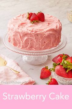 a strawberry cake on a table with strawberries