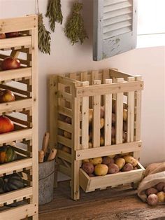 a wooden crate filled with lots of fruit next to other fruits and vegetables on a table