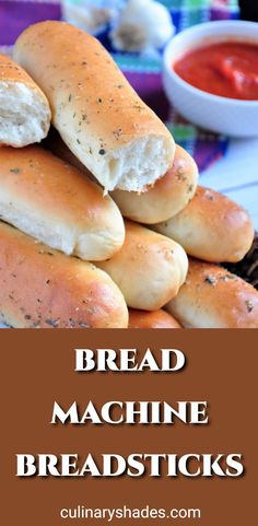 bread machine breadsticks stacked on top of each other with dipping sauce in the background