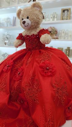 a teddy bear dressed in a red dress