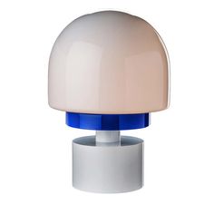 a white and blue lamp sitting on top of a table