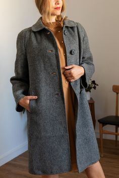 Stylish vintage coat from the 90s Lightweight with superior warmth Gray colour Small shoulder pads Side pockets Beautiful vintage buttons Excellent vintage condition Brand Indra Made in Spain Composition 100% Virgin wool Size The tag says size 46 but it fits a size L/XL (The model wears L size and is 1,75m tall)  Please check measurements before purchase Measurements Taken from seam to seam while the garment is lying flat  Shoulders: 43cm / 16,9inch Sleeves: 63cm / 24,8inch Bust: 56cm / 22inch Length: 109cm / 42,9inch PLEASE convo me if you have any further questions about this item or would like to see more pictures. I try to be as accurate as possible in the description but want you to be fully satisfied with anything you purchase! You are about to buy a vintage item. This means, the pie Vintage Single Breasted Pea Coat For Fall, Vintage Single Breasted Fall Pea Coat, Vintage Single Breasted Long Coat, Vintage Single-breasted Pea Coat For Fall, Vintage Single-breasted Fall Pea Coat, Vintage Single-breasted Long Coat, Vintage Long Single-breasted Coat, Vintage Wool Coat For Work, Vintage Long Wool Coat With Pockets