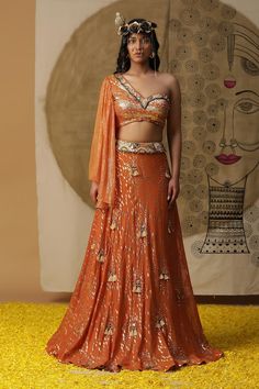 Rust orange textured lehenga with placement embroidery. Paired with a gathered blouse with matching texture and embroidery on neckline and a ruffled net dupatta. - Aza Fashions Orange Pre-draped Saree With Unstitched Blouse For Party, Orange Pre-draped Saree For Party And Festive Occasions, Festive Orange Pre-draped Saree For Party, Orange Pre-draped Saree With Dupatta For Party, Orange Lehenga With Unstitched Blouse In Georgette, Orange Zari Work Pre-draped Saree For Party, Orange Pre-draped Party Saree With Zari Work, Bollywood Style Orange Pre-draped Saree For Party, Party Orange Pre-draped Saree With Zari Work