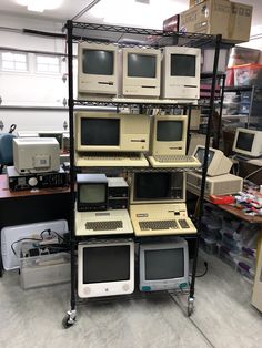 there are many old computers on display in the store, all stacked up and ready to be used