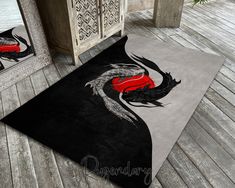 a black and red area rug with a dragon on it