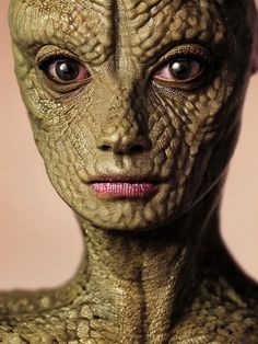 a close up of an alien woman's face