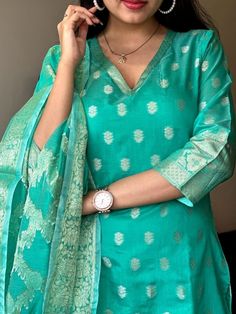 Indulge in timeless elegance with our Turquoise Chanderi Kurti Set. Crafted with pure banarsi silk jacquard and detailed with intricate self zari work, this suit is a must-have in your wardrobe. The set comes with a matching silk pant, a pure heavy banarsi self zari jacquard dupatta, and a cotton lining for added comfort. Dry clean only. Chanderi Silk Suit Designs Indian, Silk Suit Designs Indian, Banarasi Suit Designs, Banarsi Suit, Simple Indian Suits, Stitched Kurti, Dress Designs For Stitching, Cotton Suit Designs, Suit Neck Designs