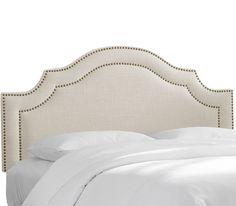 an upholstered headboard with studding and buttons