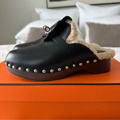 Preowned, In Good Condition. Photos Provided Of Wear And Marks. Purchased In Paris Size 36. I Am Typically A 37 So These Run Big. Original Box And Dust Bags Included. Can Provide Receipt Upon Request. Hermes Clog In Calfskin With Shearling Sole And Iconic Palladium-Plated Kelly Buckle. A Modern Take On A Boho Chic Style. Made In Italy Boho Chic Style, Hermes Shoes, Boho Chic Fashion, Mule Clogs, Mules Shoes, Calf Skin, Clogs, Chic Style, Boho Chic