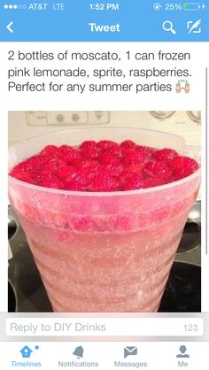 a large glass filled with raspberries on top of a stove