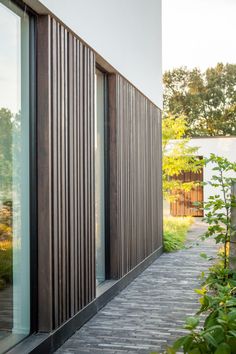 an outside walkway with wooden slats on the side