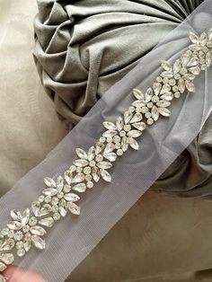 the bridal sash is adorned with crystal stones