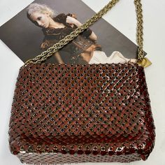 This vintage Whiting & Davis handbag from the 1970s is a must-have for any vintage fashion lover. Made from tortoiseshell mesh, this shoulder bag is both stylish and practical. The red/brown tones of the mesh give it a unique and timeless look. This original piece is in excellent condition and has been well preserved. It features the Whiting & Davis logo on the inside and is made in the United States. Perfect for any occasion, this bag is a statement piece that is sure to turn heads.  All mesh t Party Brown Shoulder Bag With Chain, Brown Chain Shoulder Bag For Party, Vintage Brown Evening Bag For Party, Evening Brown Shoulder Bag With Chain Detail, Evening Brown Shoulder Bag With Chain, Vintage Red Rectangular Shoulder Bag, Vintage Brown Party Bag, Vintage Brown Party Bags, Vintage Gold Shoulder Bag With Chain Strap