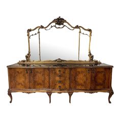 an ornately decorated dresser with mirror on top