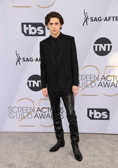 a young man in a black suit and leather pants at the screen actors'guild awards