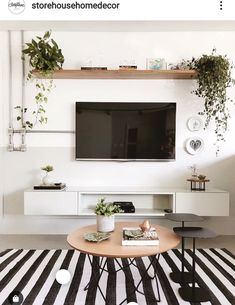 the instagram page on instagram shows an image of a living room with black and white striped rugs