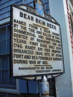 an old sign on the side of a building that says bear skin neck by the tide and kill