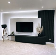 a large flat screen tv mounted to the side of a wall in a living room